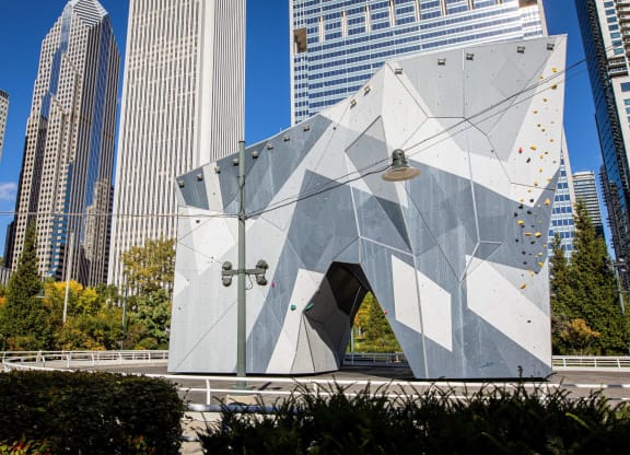 a triangular building in a city with tall skyscrapers at Columbus Plaza, Chicago, IL
