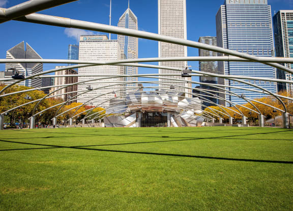 a park in the city with skyscrapers in the background at Columbus Plaza, Illinois