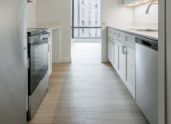 A kitchen with white appliances and cabinets at Columbus Plaza, Illinois, 60601