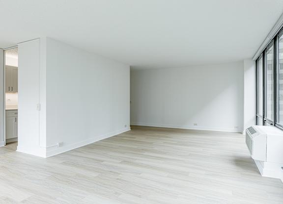 A white room with a sliding door and a window at Columbus Plaza, Chicago, 60601