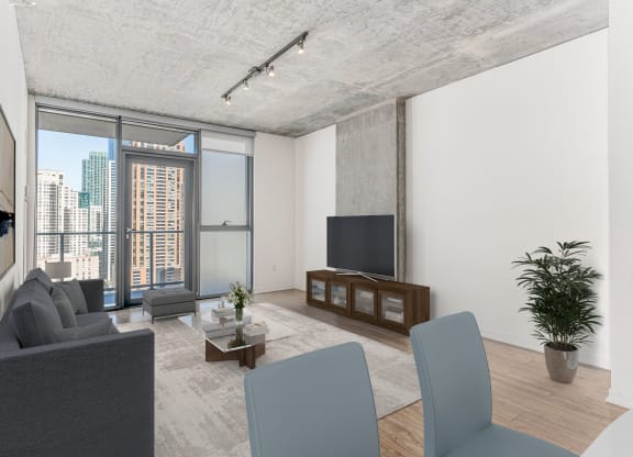 a living room with a gray couch and a tv at One 333, Chicago, Illinois