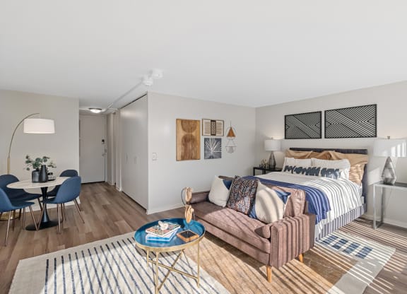 a living room with a bed and a couch  at The Pavilion, Detroit, MI, 48207