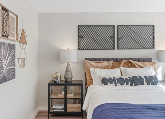 a bedroom with a bed and paintings on the wall at The Pavilion, Michigan, 48207