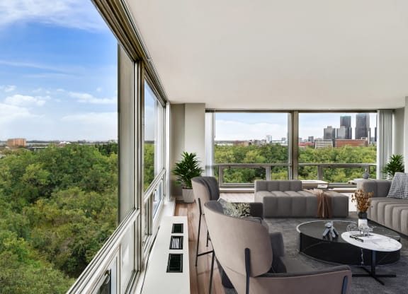 a living room with a large window and a view of the city at The Pavilion, Detroit, MI