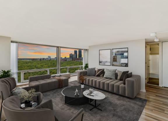 a living room with a large window and a view of the city at The Pavilion, Detroit, Michigan