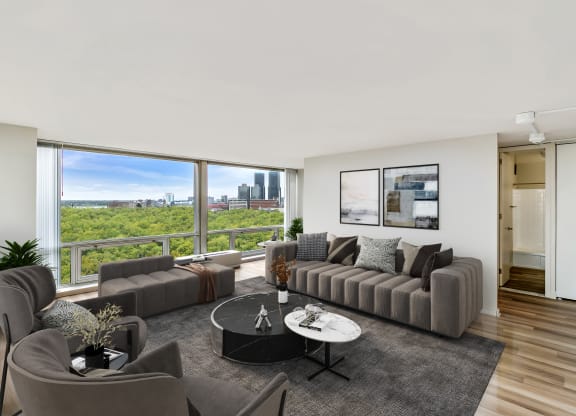 a living room with a large window and a view of the city at The Pavilion, Michigan