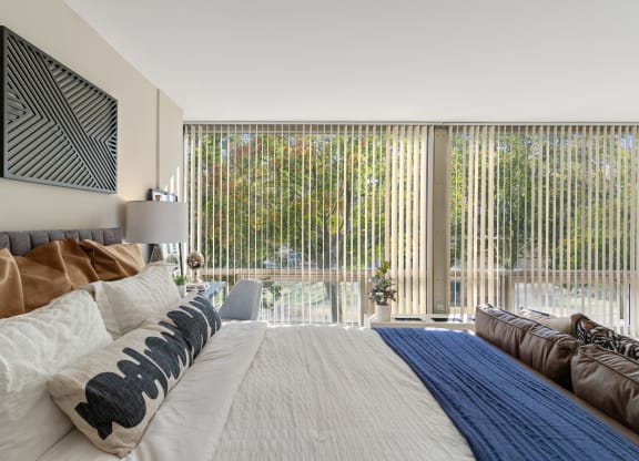 a bedroom with a large bed and a large window at the Pavilion at The Pavilion, Detroit, Michigan