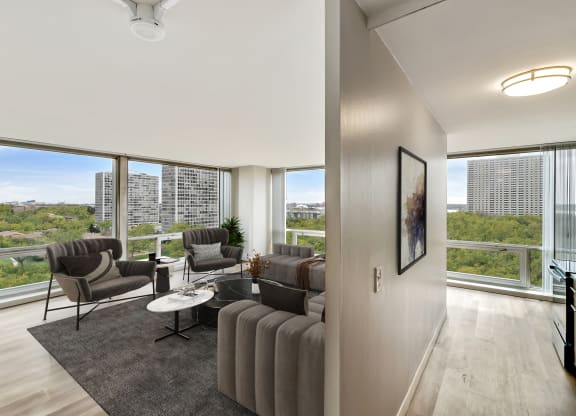 a living room with a large window and a view of the city at The Pavilion, Detroit