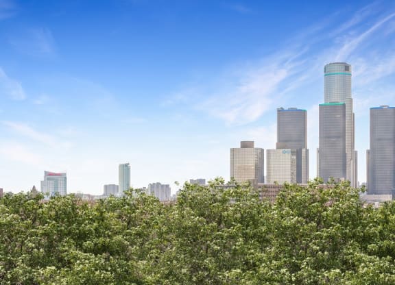 a city skyline with trees in the foreground at The Pavilion, Detroit, MI, 48207