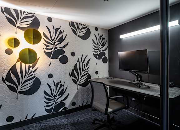 A modern office with a leaf patterned wallpaper and a desk with a computer at Kingsbury Plaza, Chicago, IL, 60654