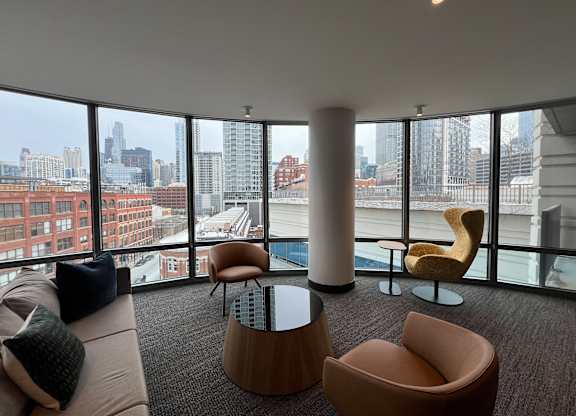 A living room with a view of the city skyline at Kingsbury Plaza, Chicago, IL, 60654