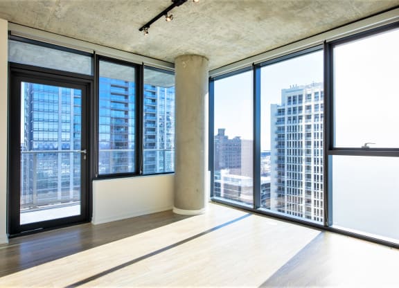 an empty living room with a view of the city at One 333, Chicago, IL, 60605