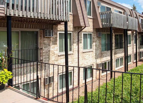 Multi story apartment building with balconies and brick exterior at Cedarvale Highlands Apartments, Minnesota