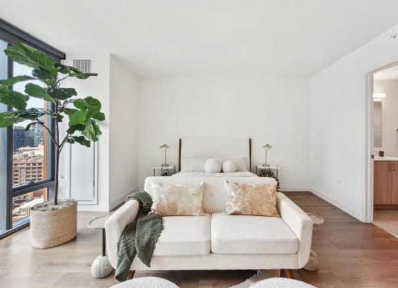 a bedroom with a couch and a bed and a large window at Cassidy on Canal, Chicago, IL, 60654