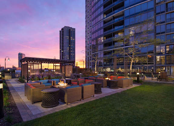 Outdoor fire pits, seating area, and gazebo at sunset at Kingsbury Plaza, Chicago, 60654
