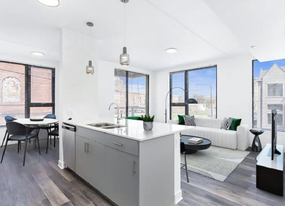an open living room with a kitchen and a table
