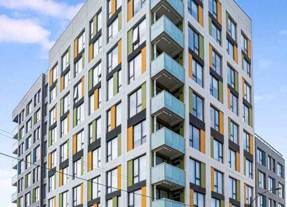 a rendering of a new apartment building on a city street