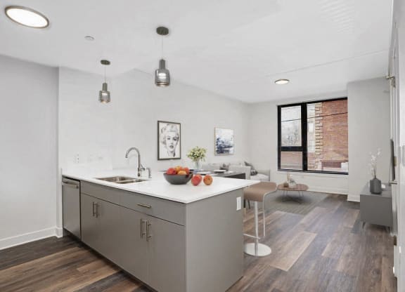 a kitchen with a large island and a living room
