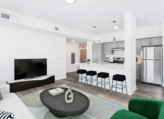 the living room and kitchen of a modern apartment