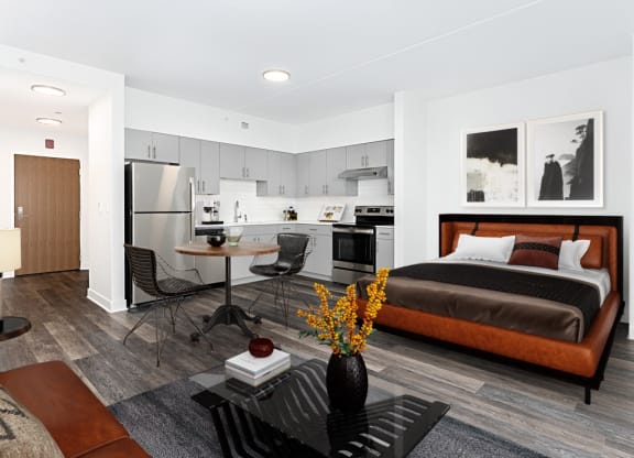 a studio apartment with a bed and a kitchen