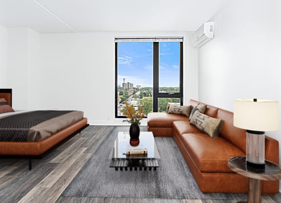 a living room with a couch and a table and a bed