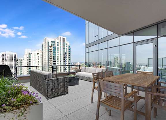 a balcony with a table and chairs and a view of the city at Cassidy on Canal, Chicago, Illinois, 60606