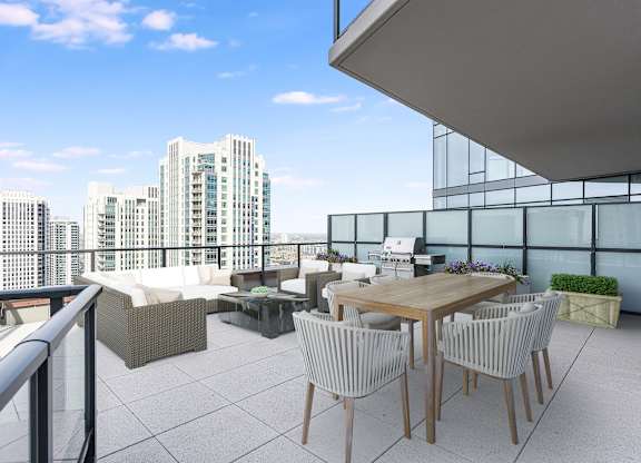 a rooftop terrace with a table and chairs and a view of the city at Cassidy on Canal, Chicago, Illinois, 60606