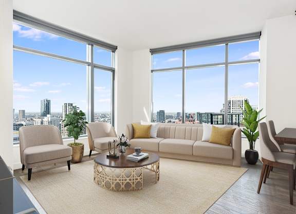 a living room with large windows and a couch and a coffee table at Cassidy on Canal, Chicago, 60606