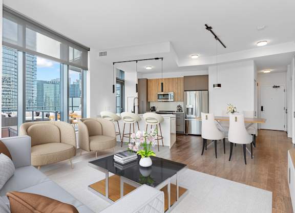 a living room with a couch and a table and a kitchen at Cassidy on Canal, Chicago, 60606