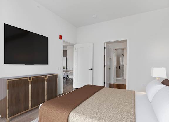 a bedroom with a bed and a tv on the wall at Cassidy on Canal, Chicago, IL