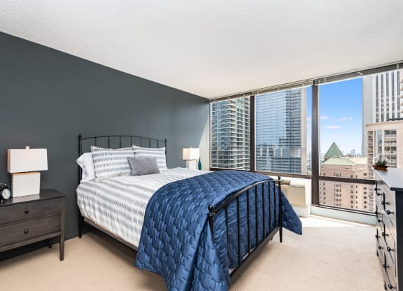 a bedroom with a large bed and a large window at Columbus Plaza, Chicago, IL