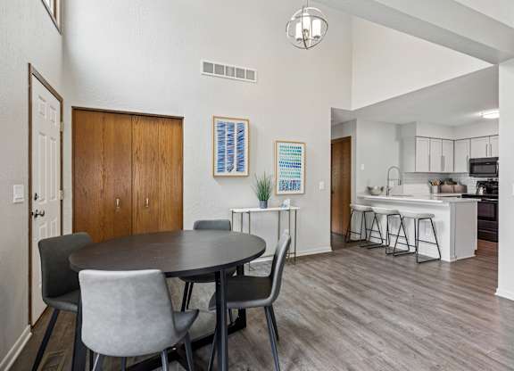A dining room with a round table and chairs at Seasons Villas Apartments, Woodbury, Minnesota