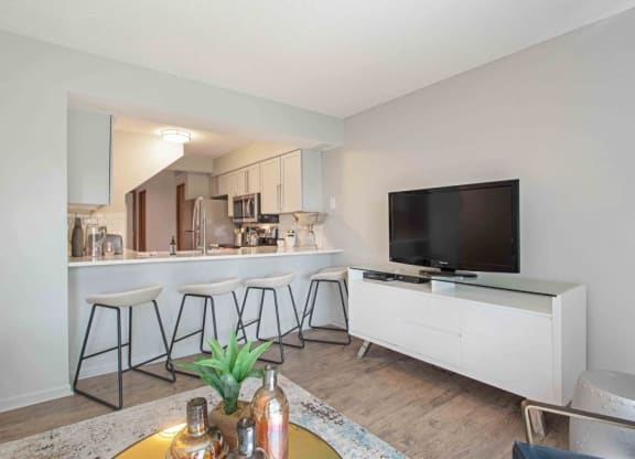 a living room with a bar and a television at Seasons Villas, Woodbury Minnesota