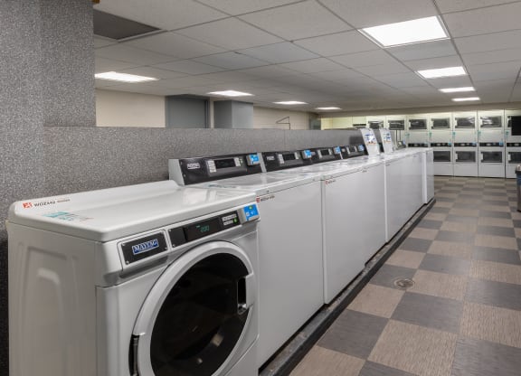 a row of washing machines in a public laundromat at The Pavilion, Detroit, MI, 48207
