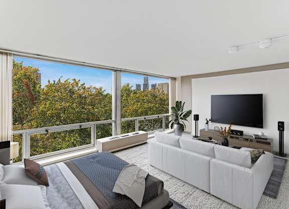 A modern living room with a large window overlooking a city skyline.