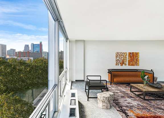 A modern living room with a view of the city skyline.