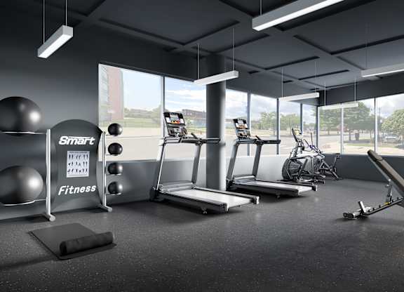 a workout room with weights and other exercise equipment and windows