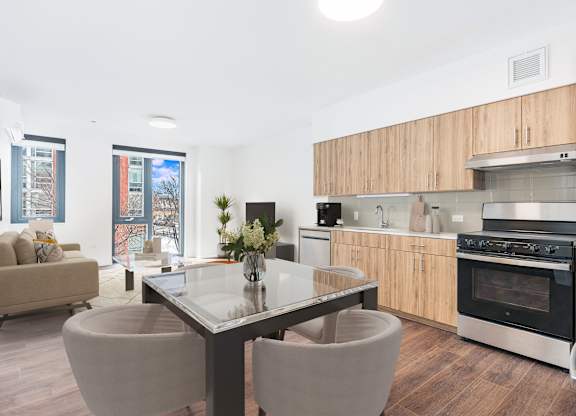 A modern kitchen with a glass table and chairs.
