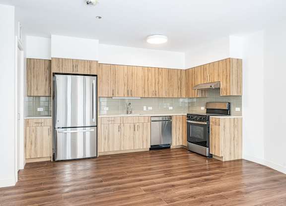 A modern kitchen with wooden cabinets and stainless steel appliances.
