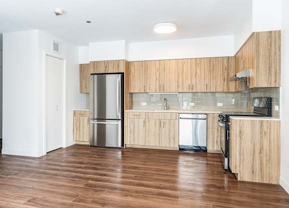 A kitchen with wooden cabinets and stainless steel appliances.