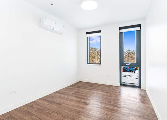 A room with a window and a door.