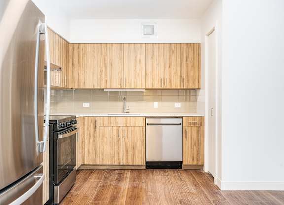 A kitchen with wooden cabinets and stainless steel appliances.
