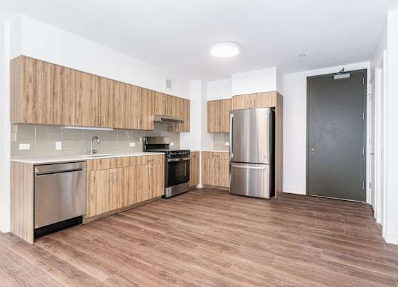 A kitchen with wooden cabinets and stainless steel appliances.