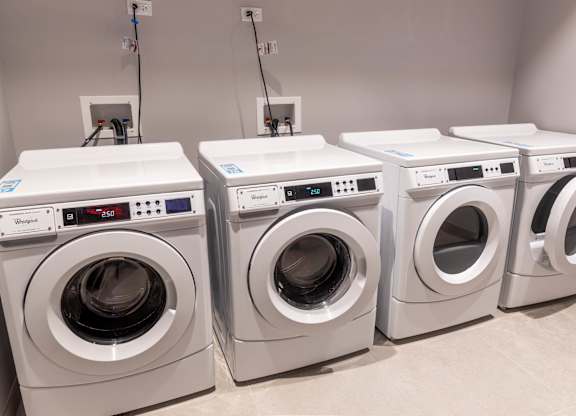 Shared laundry room with front load washers at Thrive Exchange Apartments, Chicago, Illinois