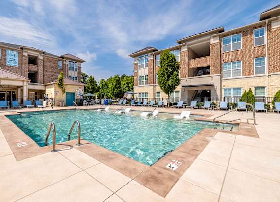 A swimming pool in front of apartment buildings at 1701 North Apartment Homes Apartments, North Carolina