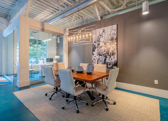 A conference room with a long table and chairs at 1701 North Apartment Homes Apartments, Chapel Hill, North Carolina