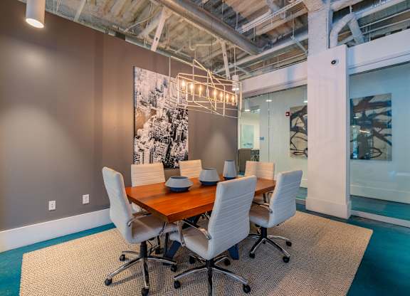 A conference room with a long table and chairs at 1701 North Apartment Homes Apartments, North Carolina