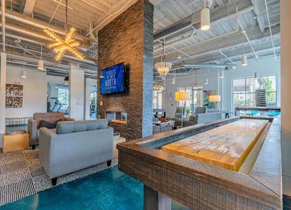 A billiard table in a room with a TV mounted on the wall at 1701 North Apartment Homes Apartments, North Carolina