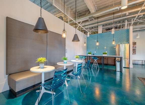 A room with a blue floor and a white table with chairs at 1701 North Apartment Homes Apartments, Chapel Hill, NC