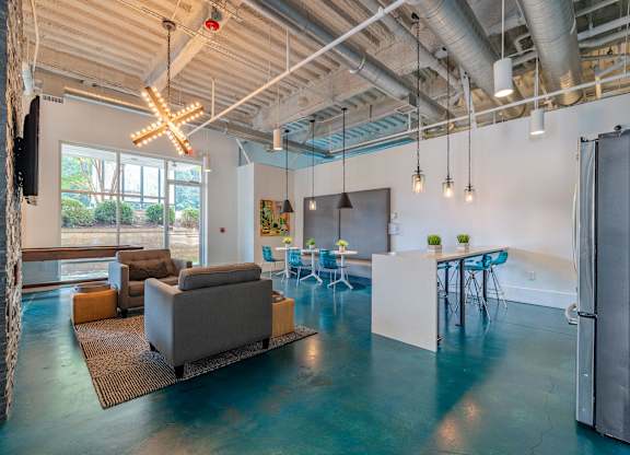 A modern open plan living and working space with a kitchen area at 1701 North Apartment Homes Apartments, Chapel Hill, 27514